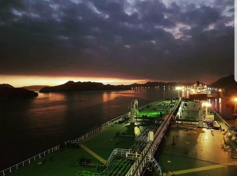 Tanker cargo deck at dusk during port operations